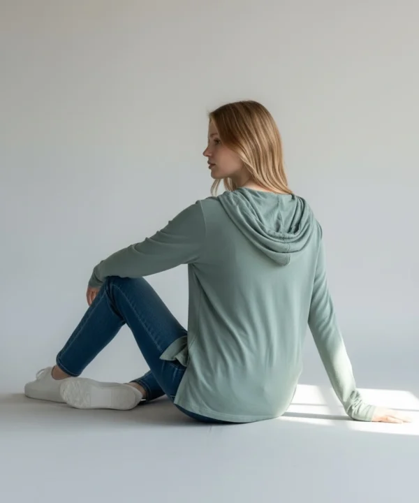 Back view of Trasaga Transit Air-Cotton hoodie in sage green showing hood and tunic length
